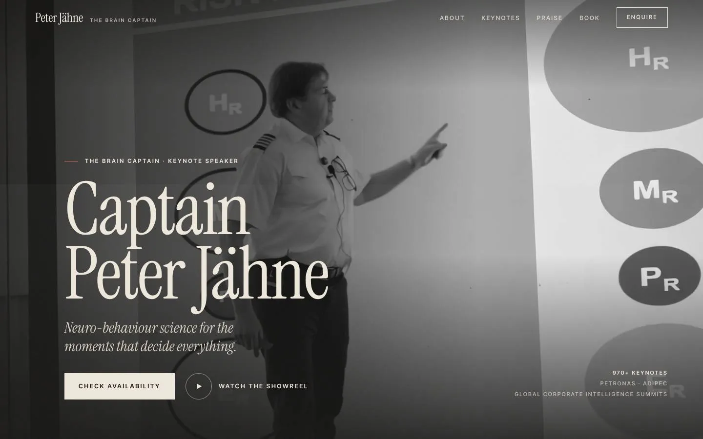 A keynote speaker's website: a black-and-white film of him on stage behind his name.